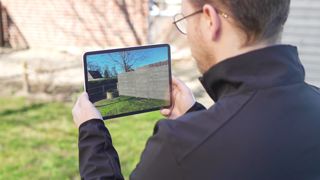 Mann mit Tablet plant virtuellen Sichtschutz, Osmo